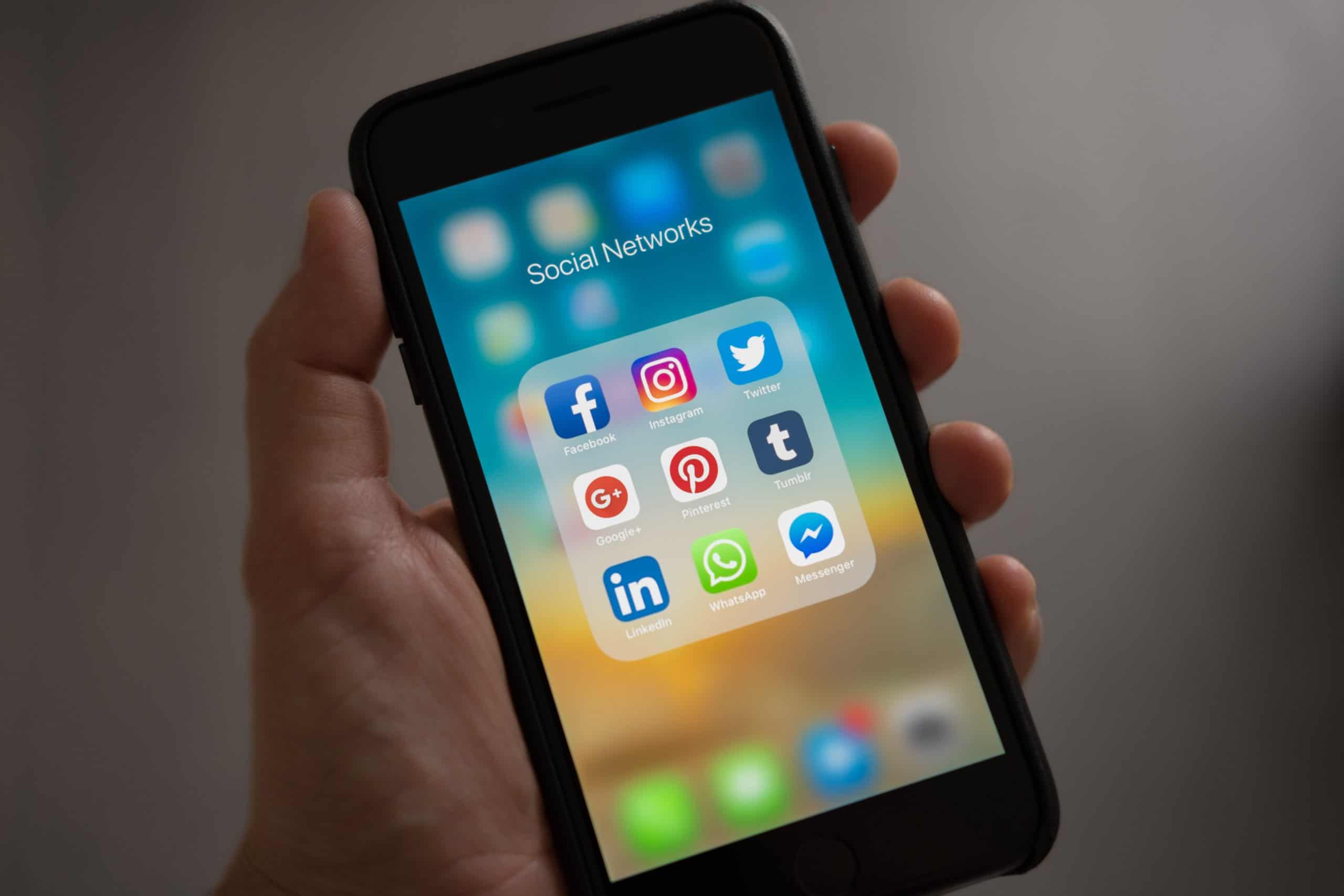 Hand holding social media on phone