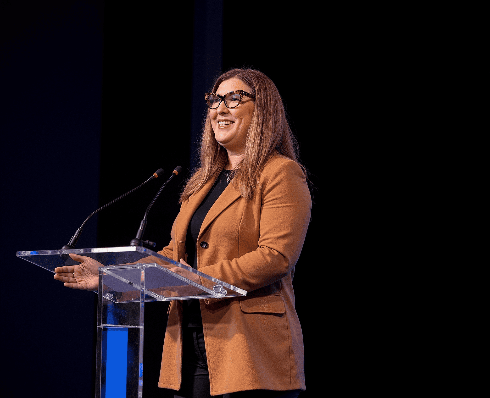 Lisa Benson speaking on stage about marketing and business systems