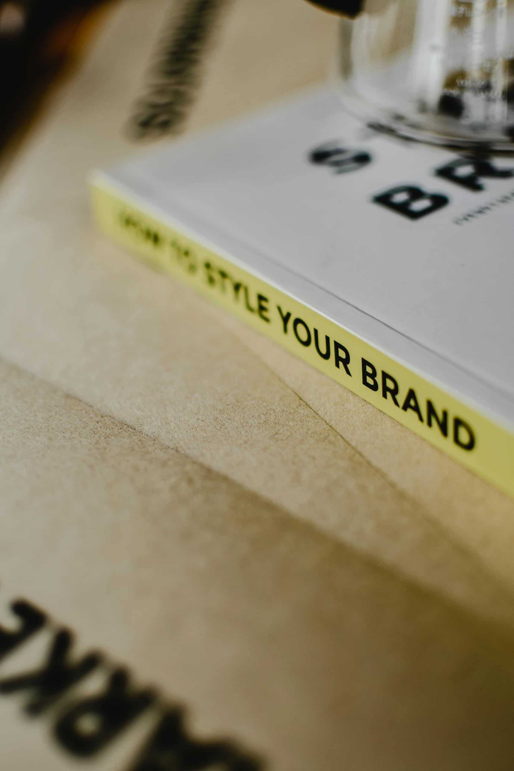 A close-up of a book titled "How to Style Your Brand" on a paper background. The Ultimate Guide to Branding Services: What They Are, Why They Matter, and How to Get It Right