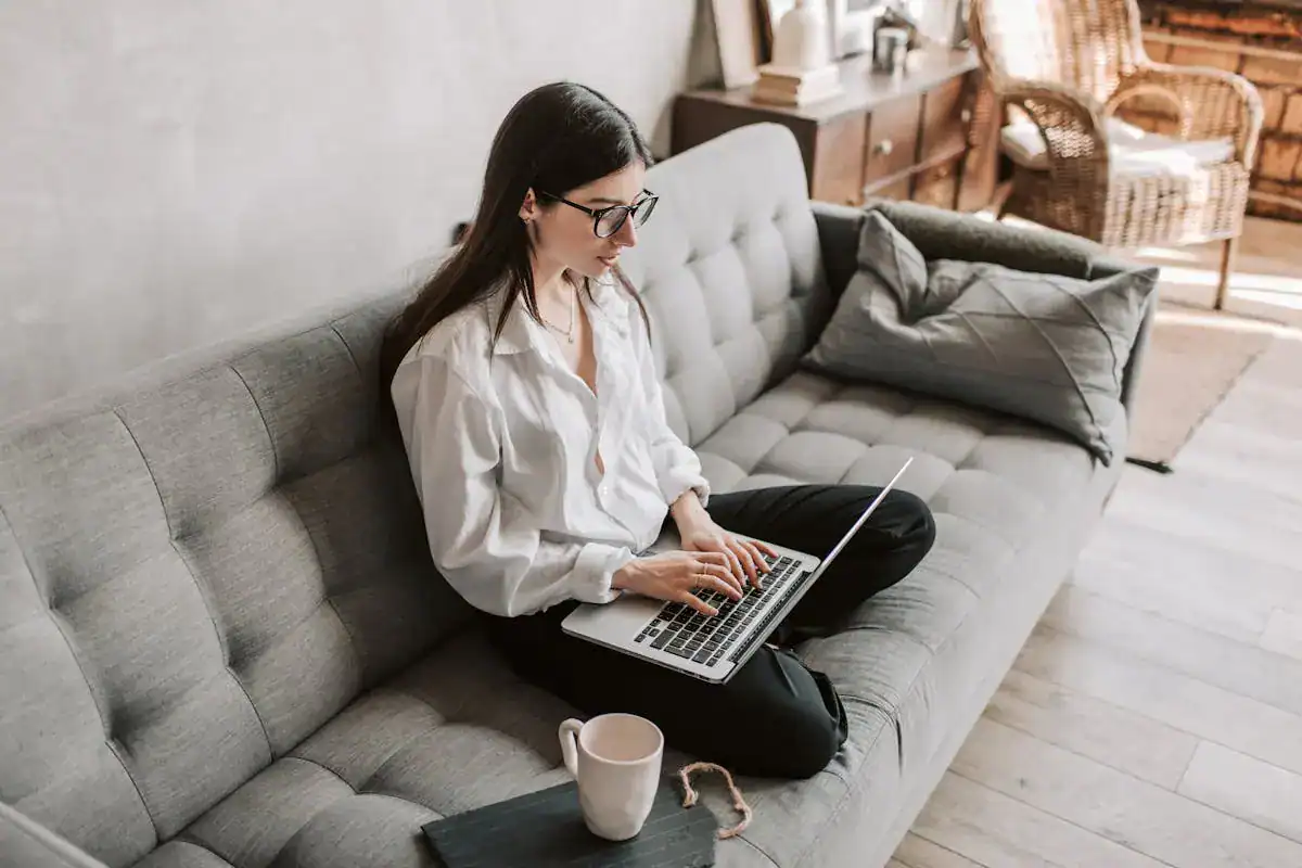 Woman on the couch working hard