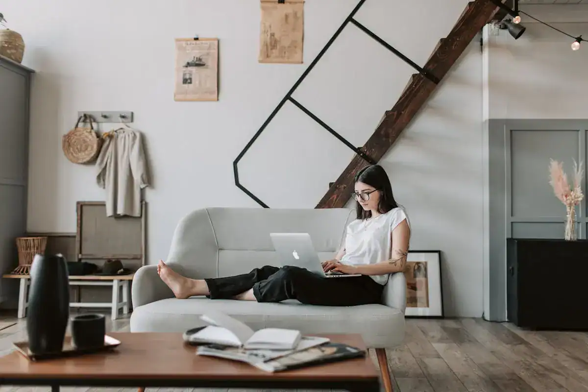 Woman on the coach working, getting her business coaching done